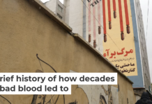 An Iranian walks past an anti-U.S. mural in Tehran on April 5, 2025. Atta Kenare/AFP via Getty Images